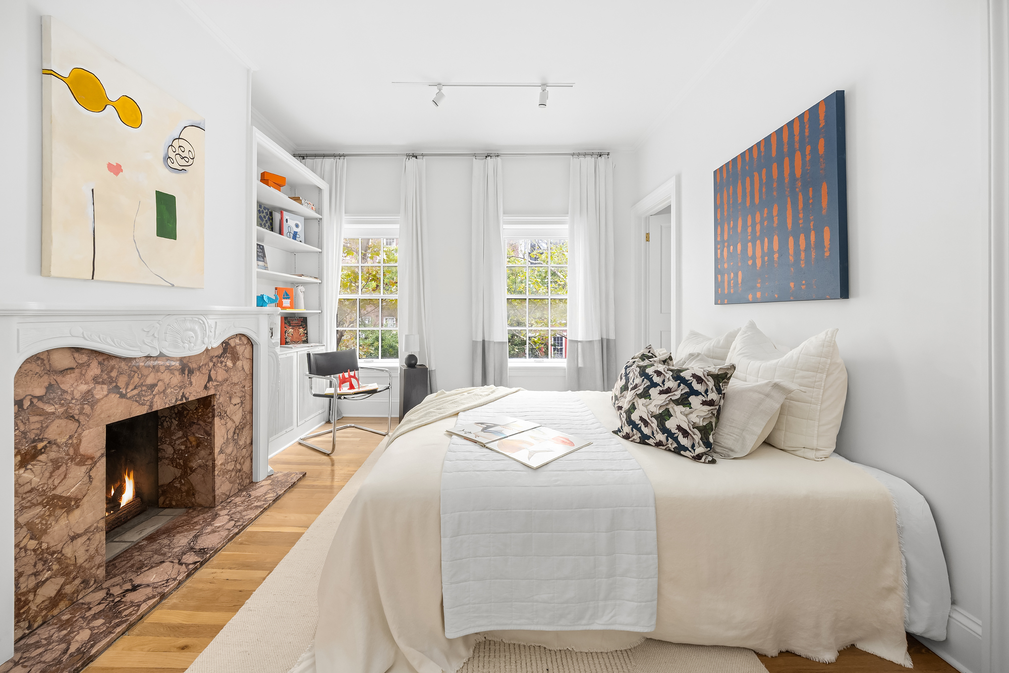 112 West 13th Street Manhattan, NY 10011 - Photo 30 of 46 a bedroom with a bed and a fireplace