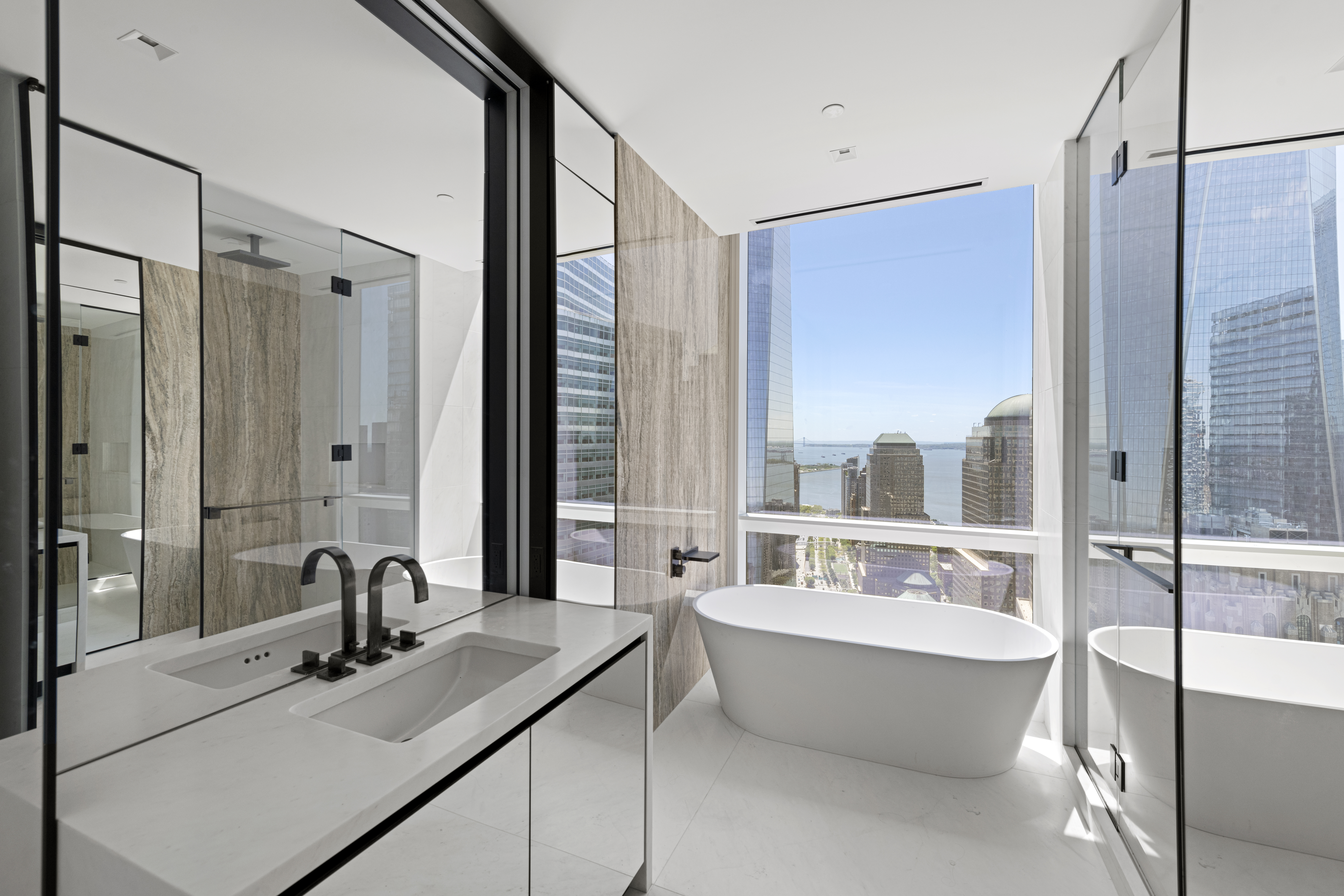 111 Murray Street, Unit 51EAST Manhattan, NY 10007 - Photo 16 of 42 a bathroom with a tub sink and mirror