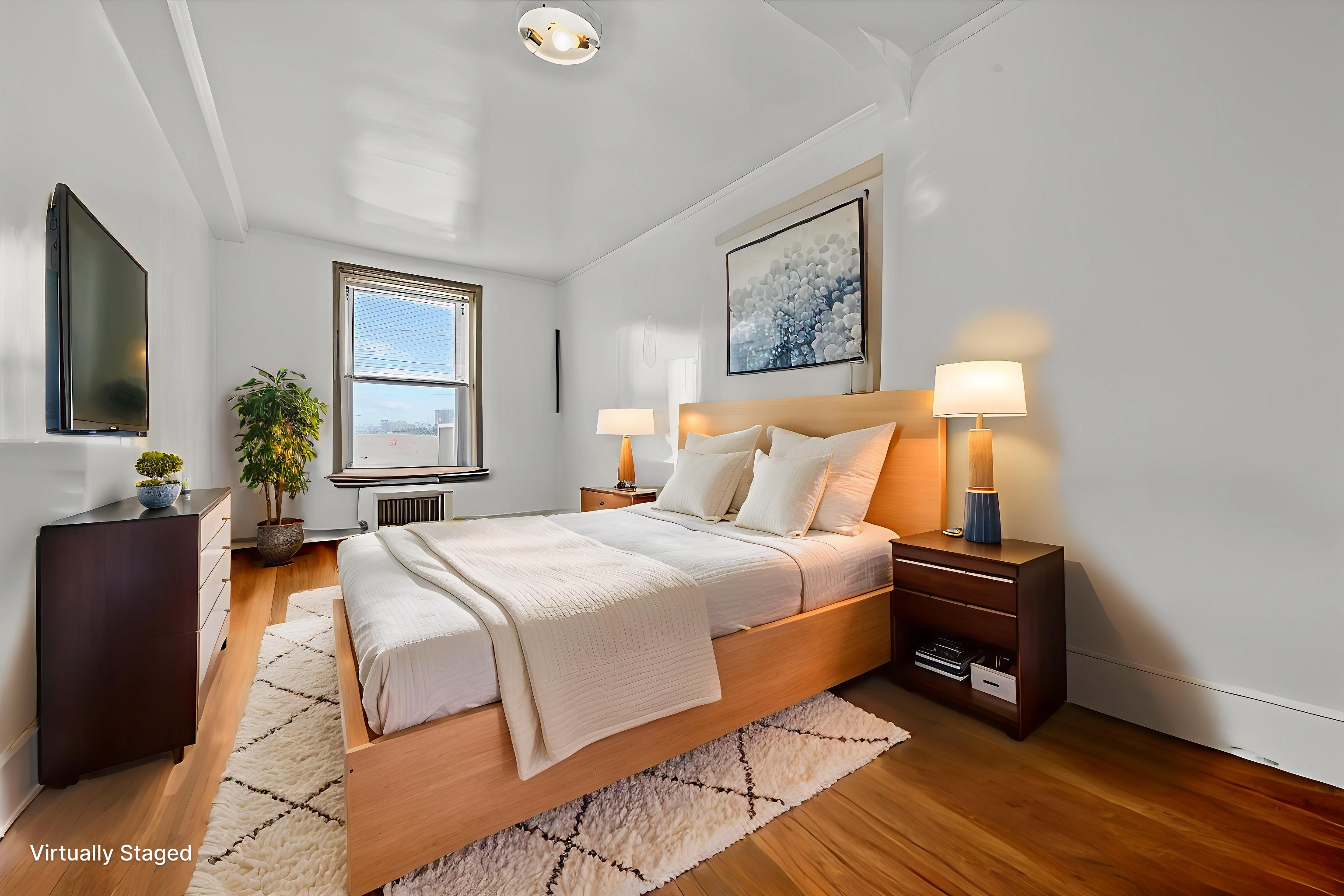 286 Corbin Place, Unit 1D Brooklyn, NY 11235 - Photo 8 of 12 a bedroom with a bed and wooden floor