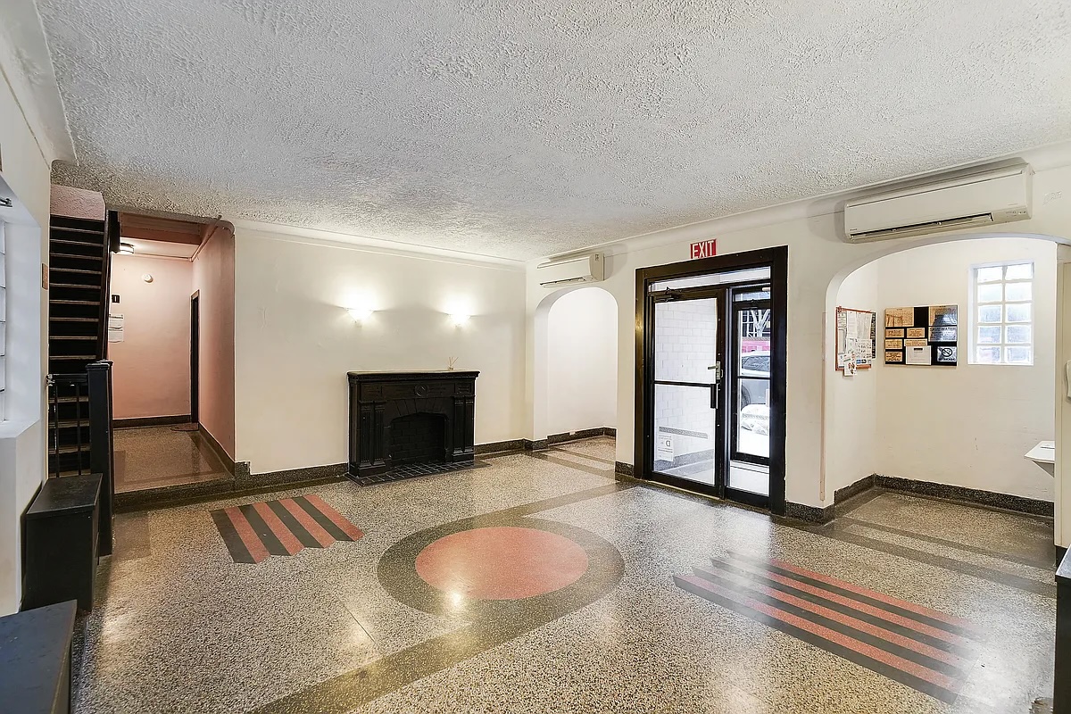 240 East 24th Street, Unit 4G Manhattan, NY 10010 - Photo 6 of 9 a view of a livingroom with furniture and fireplace