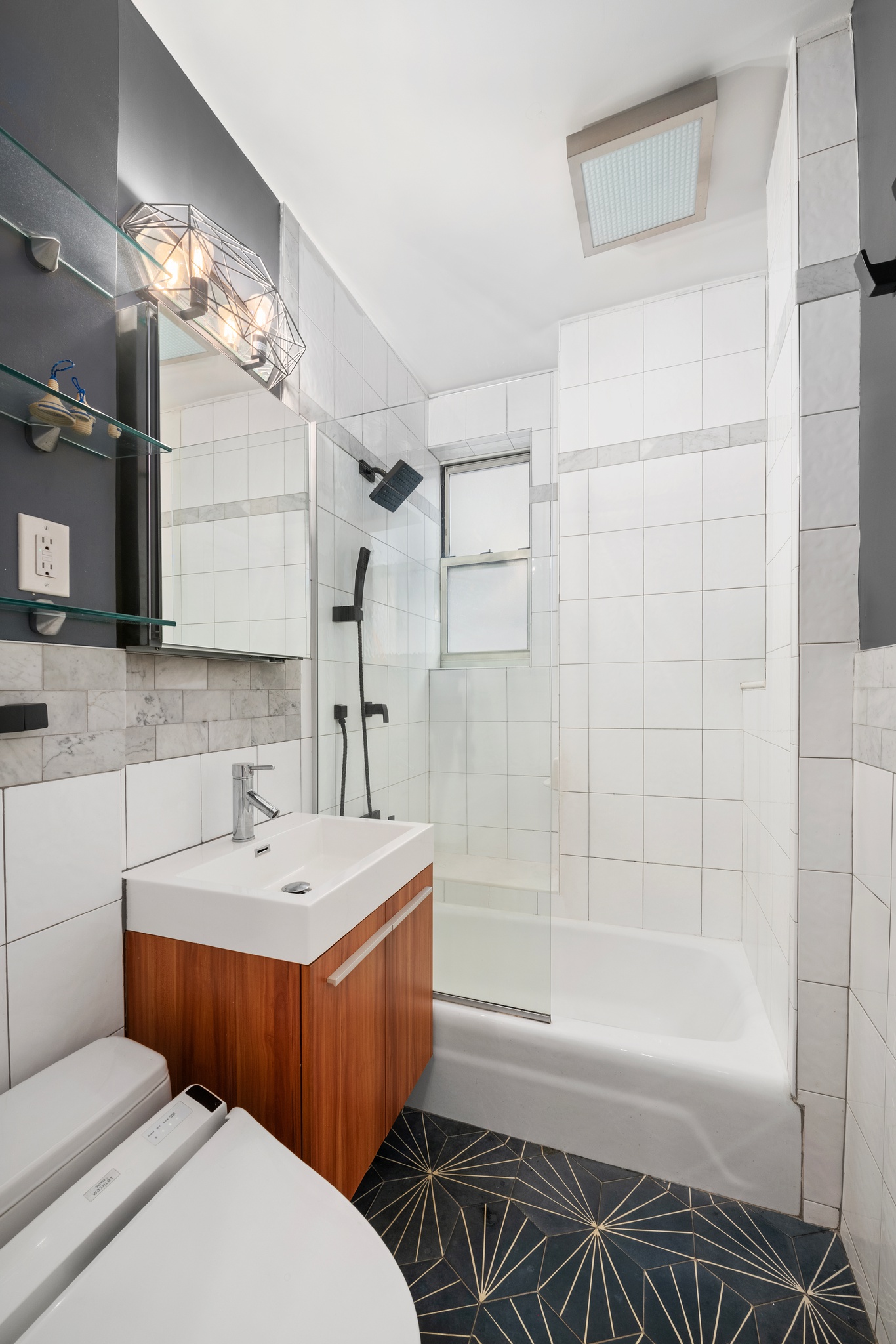 136 East 36th Street, Unit 3D Manhattan, NY 10016 - Photo 6 of 9 a bathroom with a sink a toilet and shower