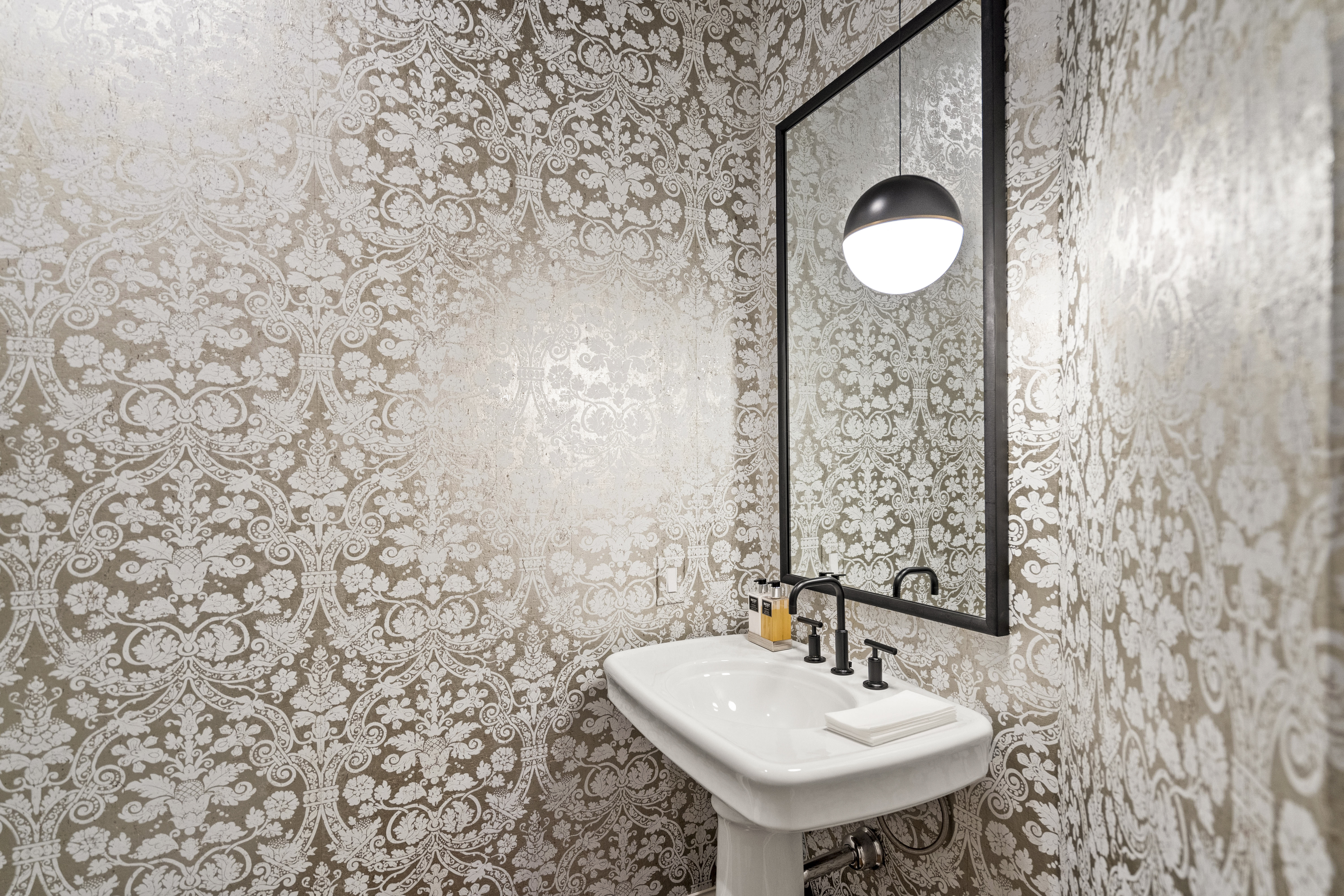 6607 Meadow Road Dallas, TX 75230 - Photo 16 of 32 a bathroom with a sink and a mirror