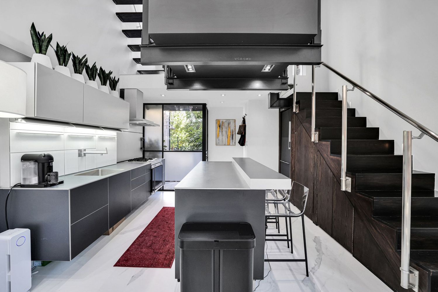 1630 19th Street Northwest, Unit C Washington, DC 20009 - Photo 12 of 45 a kitchen with granite countertop a stove and a refrigerator