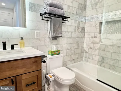 a bathroom with a sink a toilet and bathtub