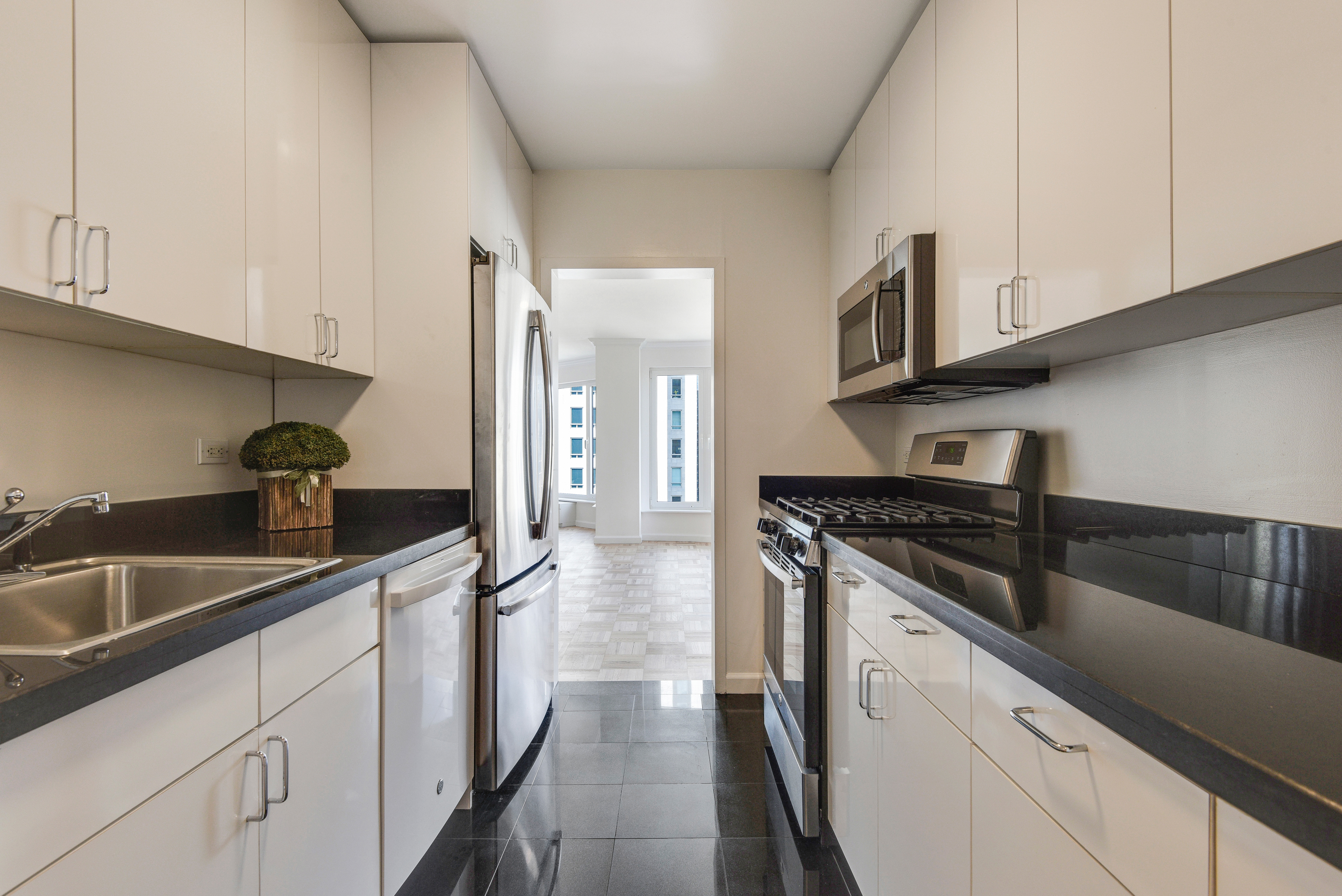 200 Central Park South, Unit 29C Manhattan, NY 10019 - Photo 7 of 23 a kitchen with stainless steel appliances granite countertop a sink and a stove