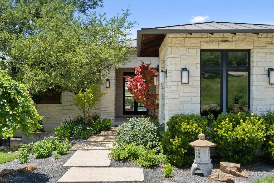 a front view of a house with a garden