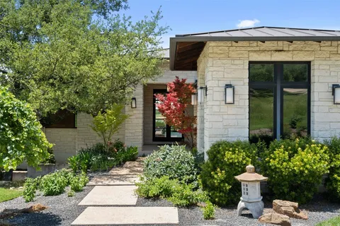 a front view of a house with a garden
