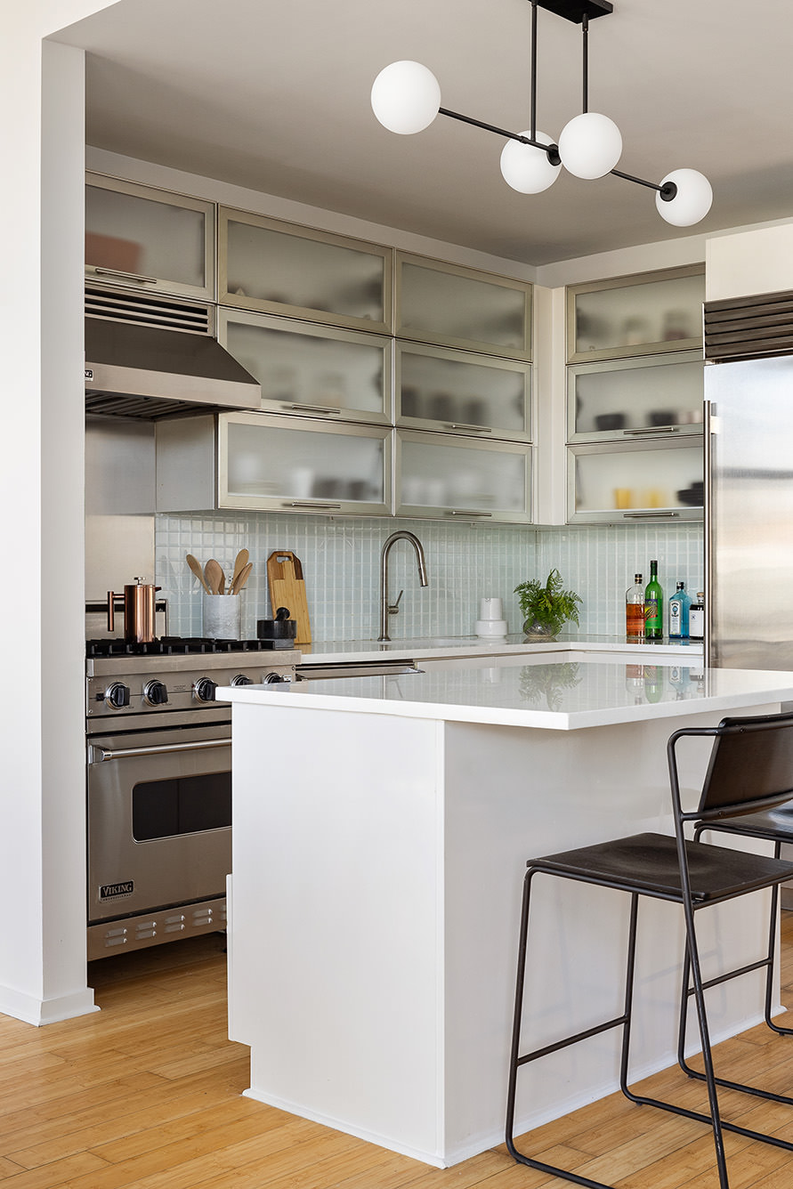 105 Norfolk Street, Unit 6A Manhattan, NY 10002 - Photo 6 of 11 a kitchen with stainless steel appliances granite countertop a sink and cabinets