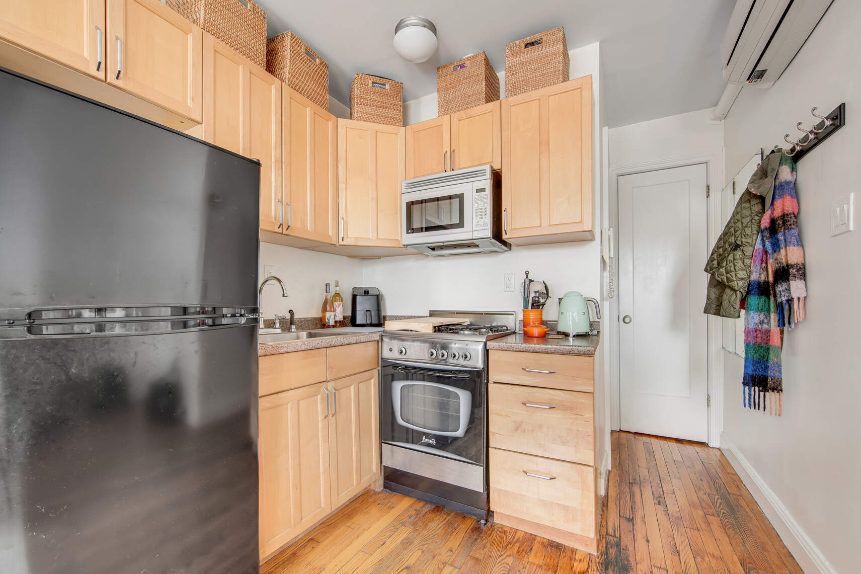 352 West 12th Street, Unit 5D Manhattan, NY 10014 - Photo 8 of 11 a kitchen with granite countertop a stove and a sink