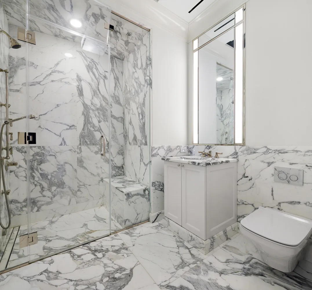 a bathroom with a sink toilet and mirror