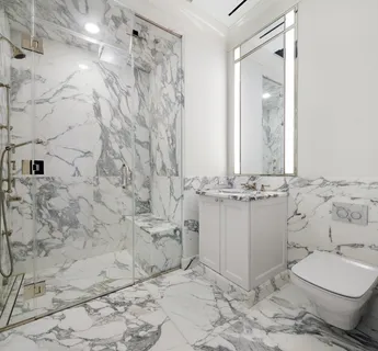 a bathroom with a sink toilet and mirror