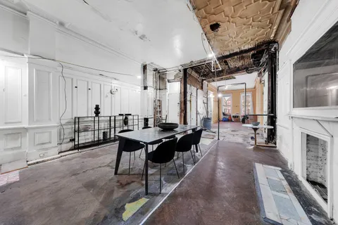 a lobby with furniture wooden floor and a fireplace