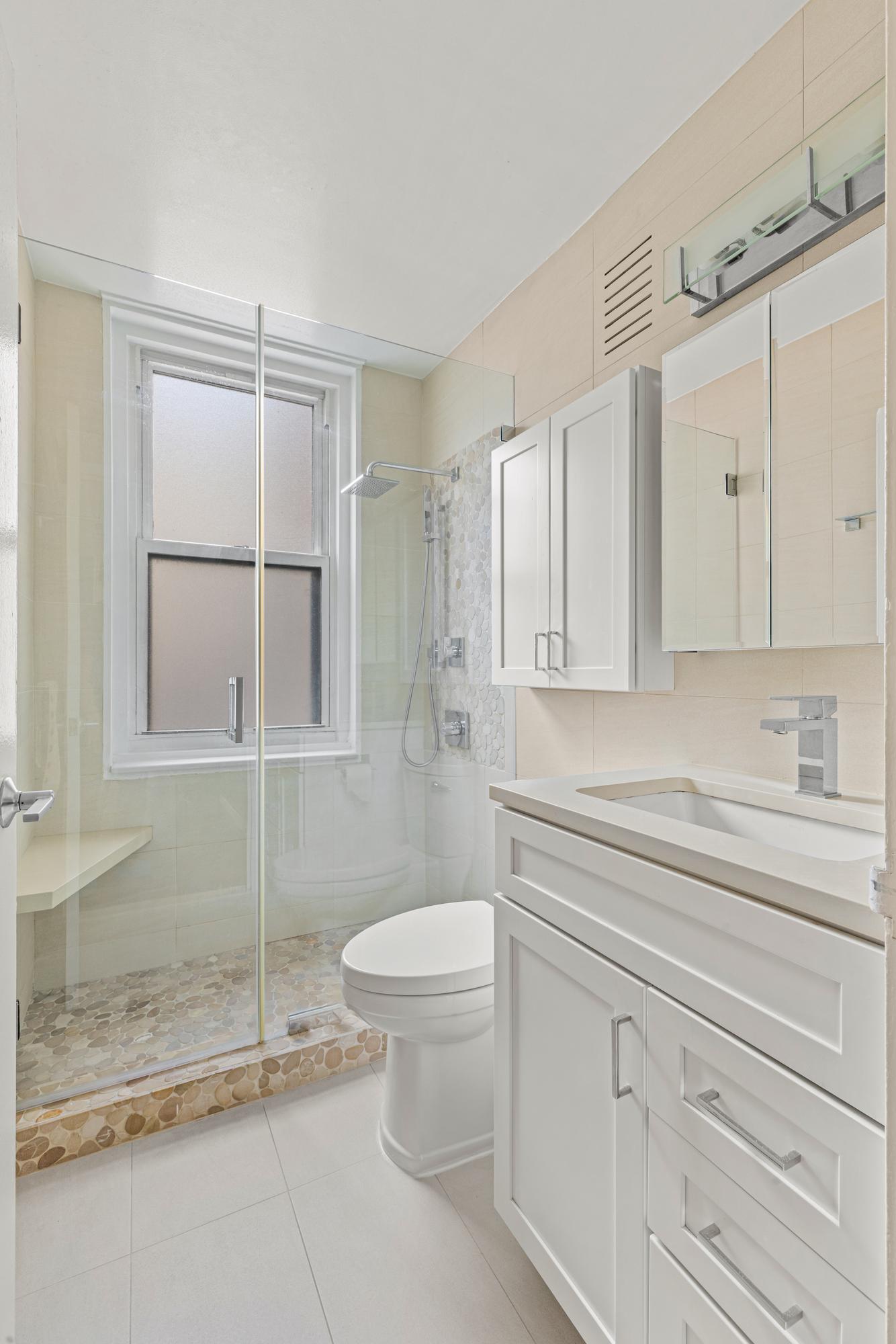 2025 Broadway, Unit 5K Manhattan, NY 10023 - Photo 5 of 15 a bathroom with a granite countertop sink mirror vanity and toilet