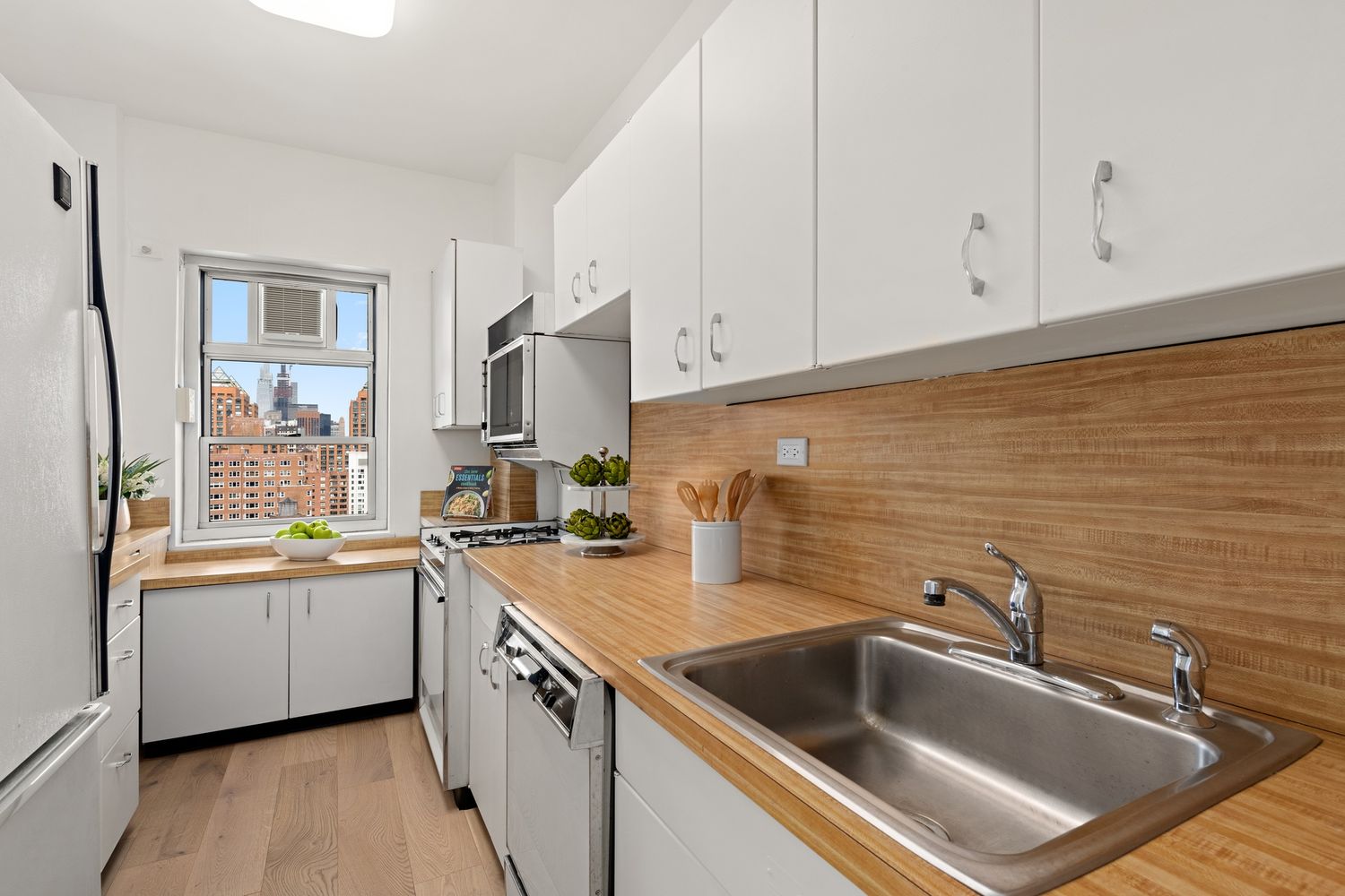 a kitchen with a sink cabinets and stainless steel appliances
