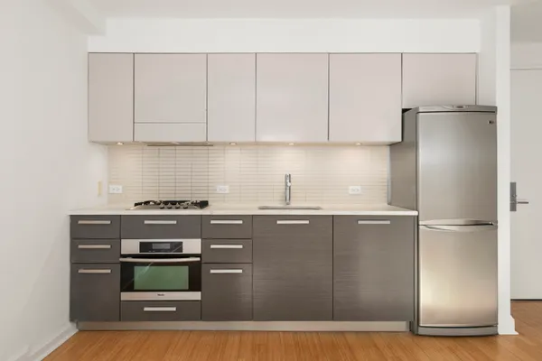 a kitchen with stainless steel appliances granite countertop a stove a refrigerator and a refrigerator