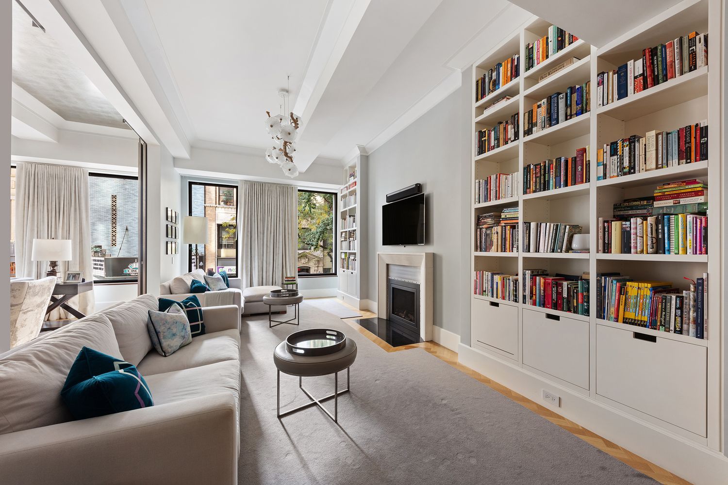 a living room with fireplace furniture and a book shelf