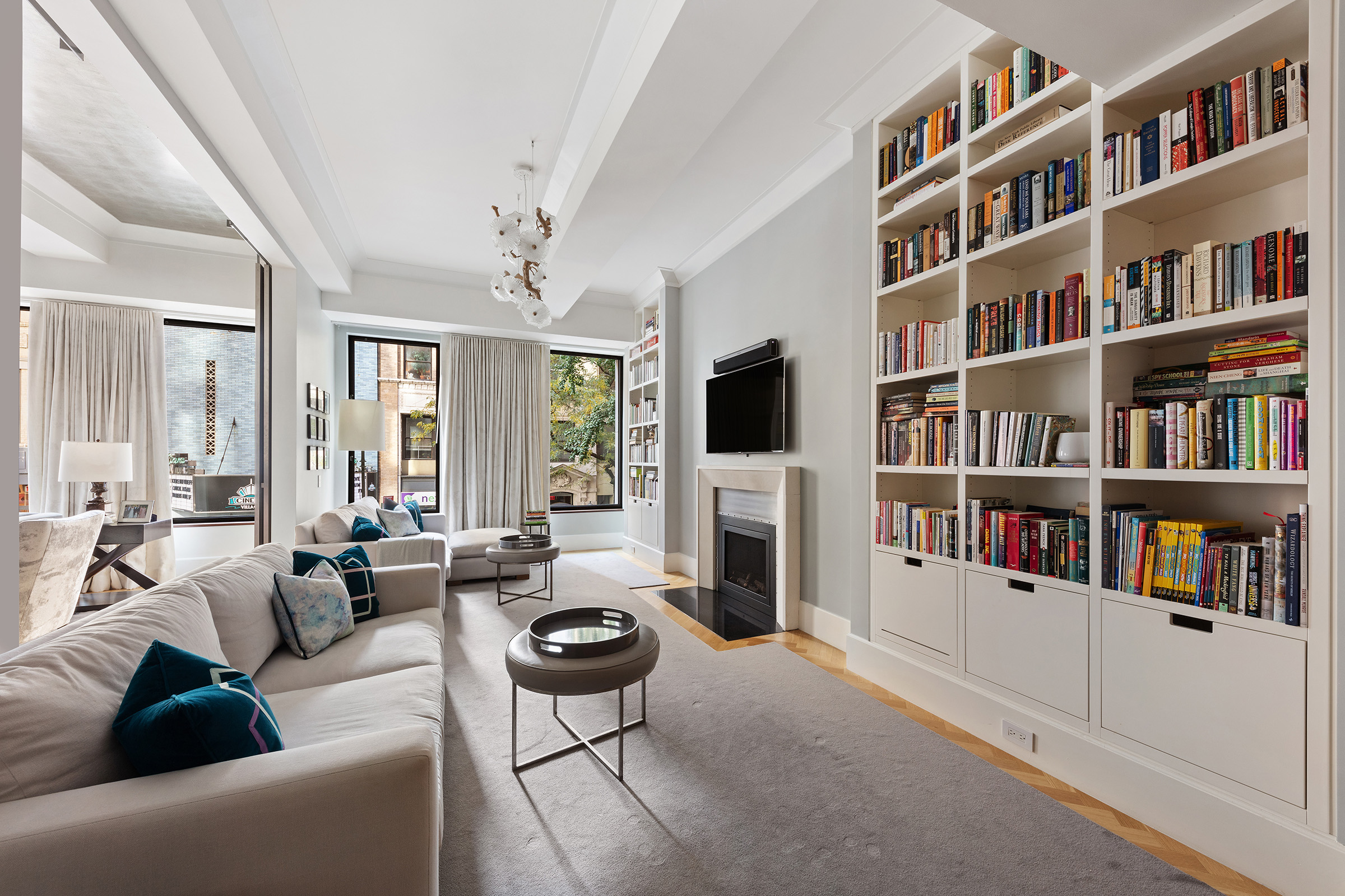 17 East 12th Street, Unit 2 Manhattan, NY 10003 - Photo 7 of 19 a living room with fireplace furniture and a book shelf