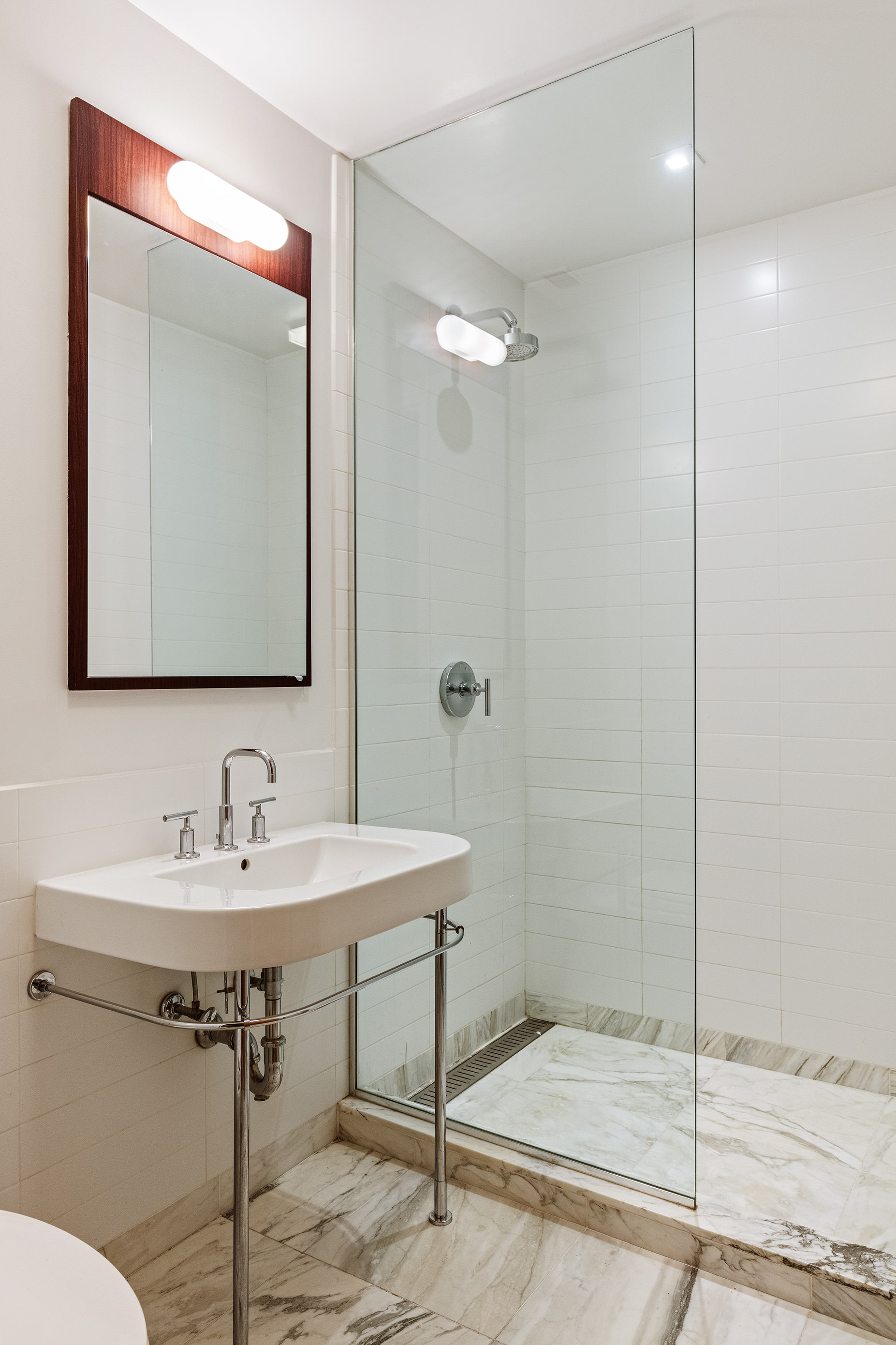 122 Greenwich Avenue, Unit 6 Manhattan, NY 10011 - Photo 8 of 13 a bathroom with a sink mirror and a shower