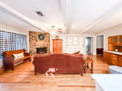 a living room with furniture window and wooden floor