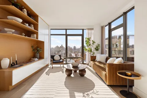 a living room with furniture and a floor to ceiling window