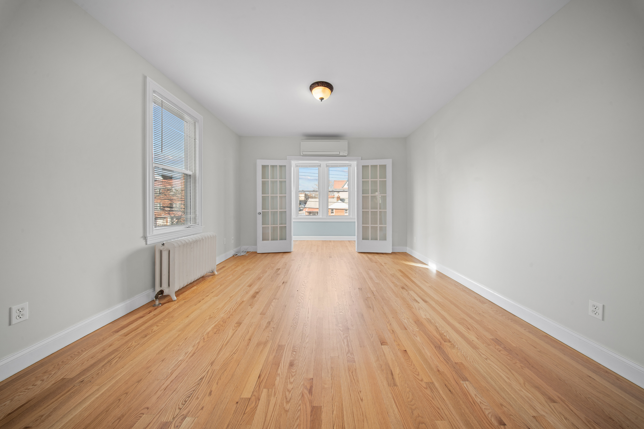 52-19 69th Street Queens, NY 11378 - Photo 17 of 35 wooden floor in an empty room with a window