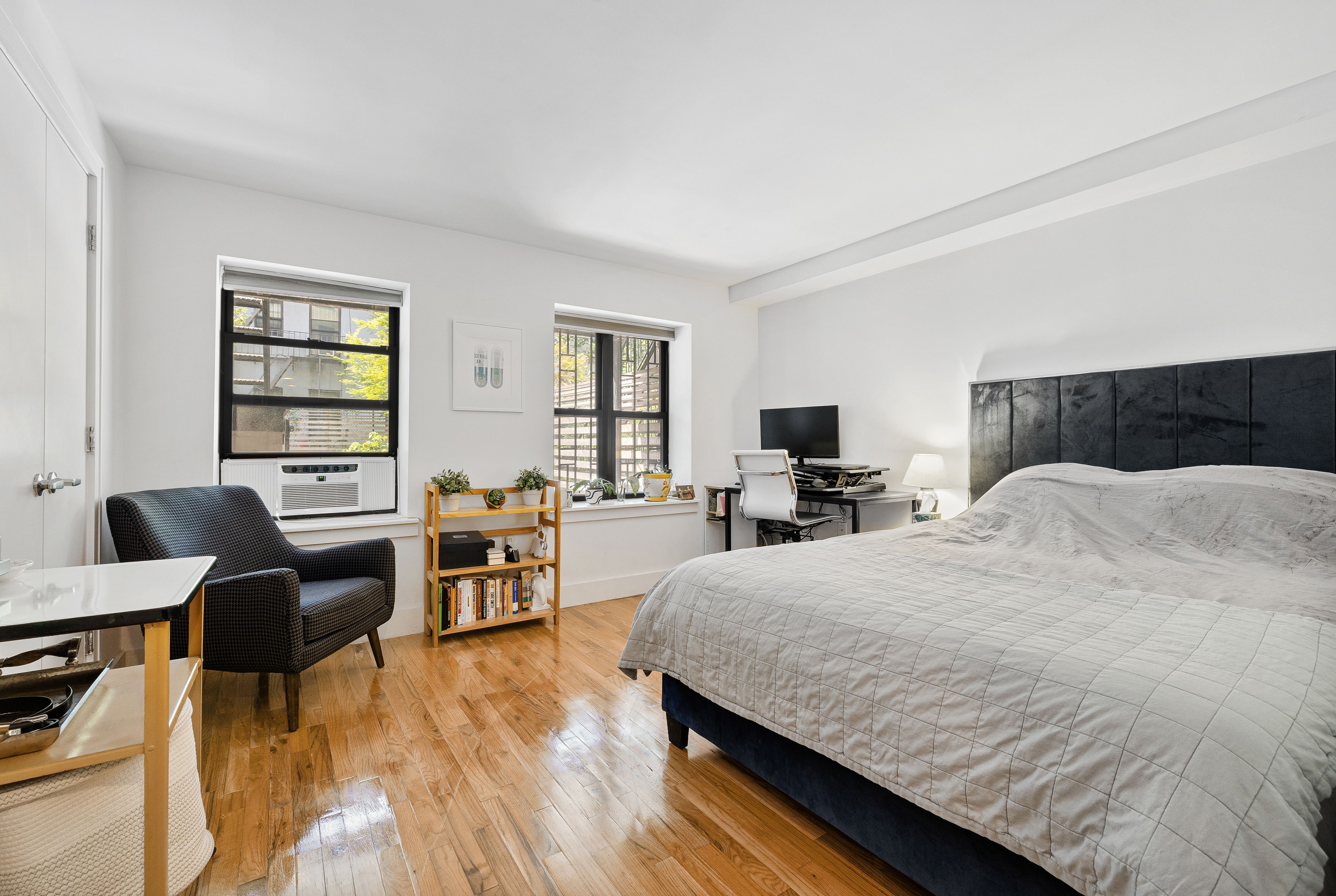 160 West 128th Street, Unit 1 Manhattan, NY 10027 - Photo 2 of 5 a living room with furniture and a flat screen tv