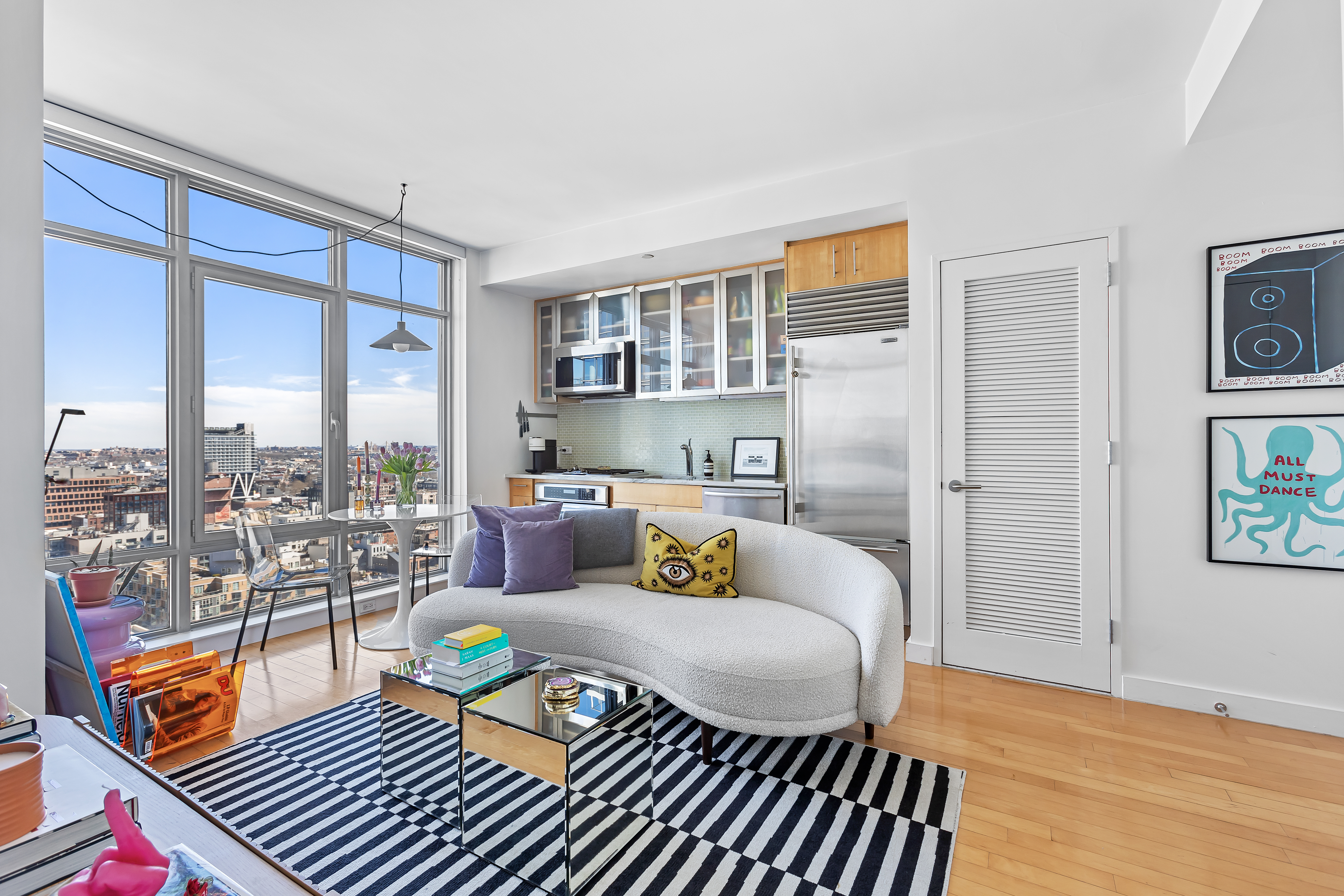 1 Northside Piers, Unit 23A Brooklyn, NY 11249 - Photo 2 of 5 a living room with furniture and a floor to ceiling window