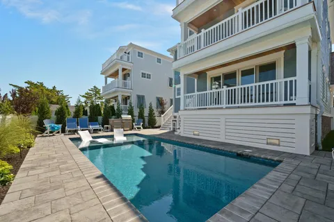 a view of house with swimming pool outdoor seating