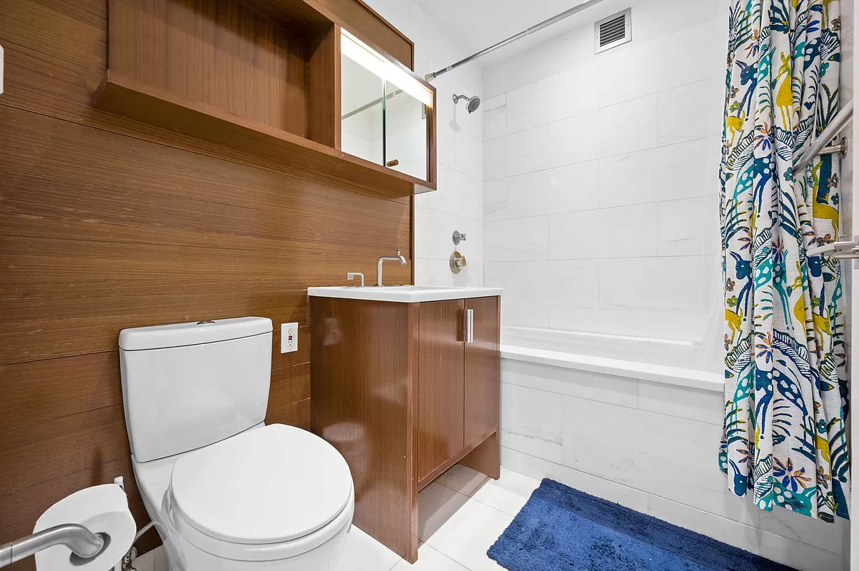 60 Riverside Boulevard, Unit 2004 Manhattan, NY 10069 - Photo 3 of 18 a white toilet sitting next to a shower curtain