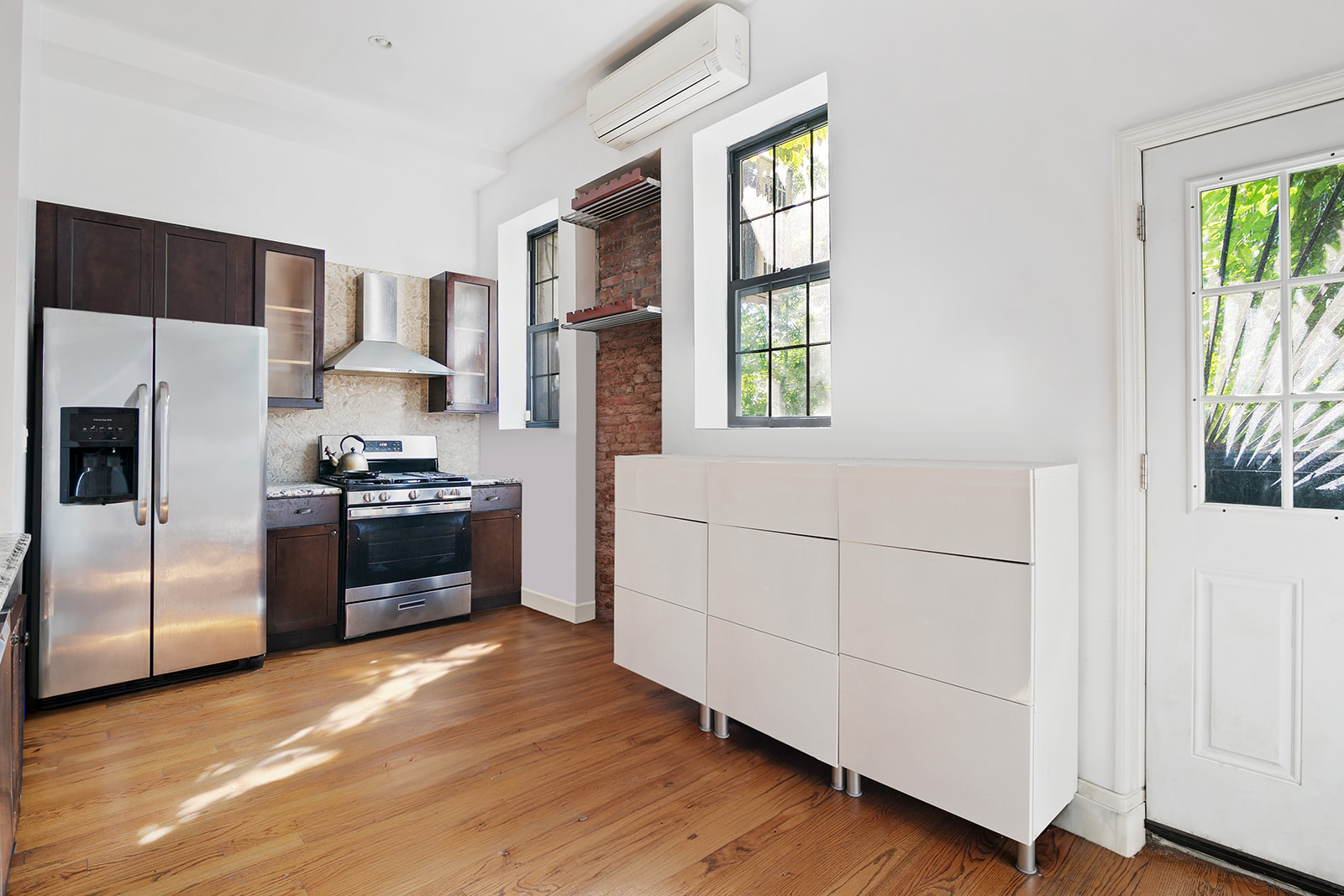900 Lafayette Avenue Brooklyn, NY 11221 - Photo 4 of 13 a kitchen with stainless steel appliances a refrigerator and a stove top oven