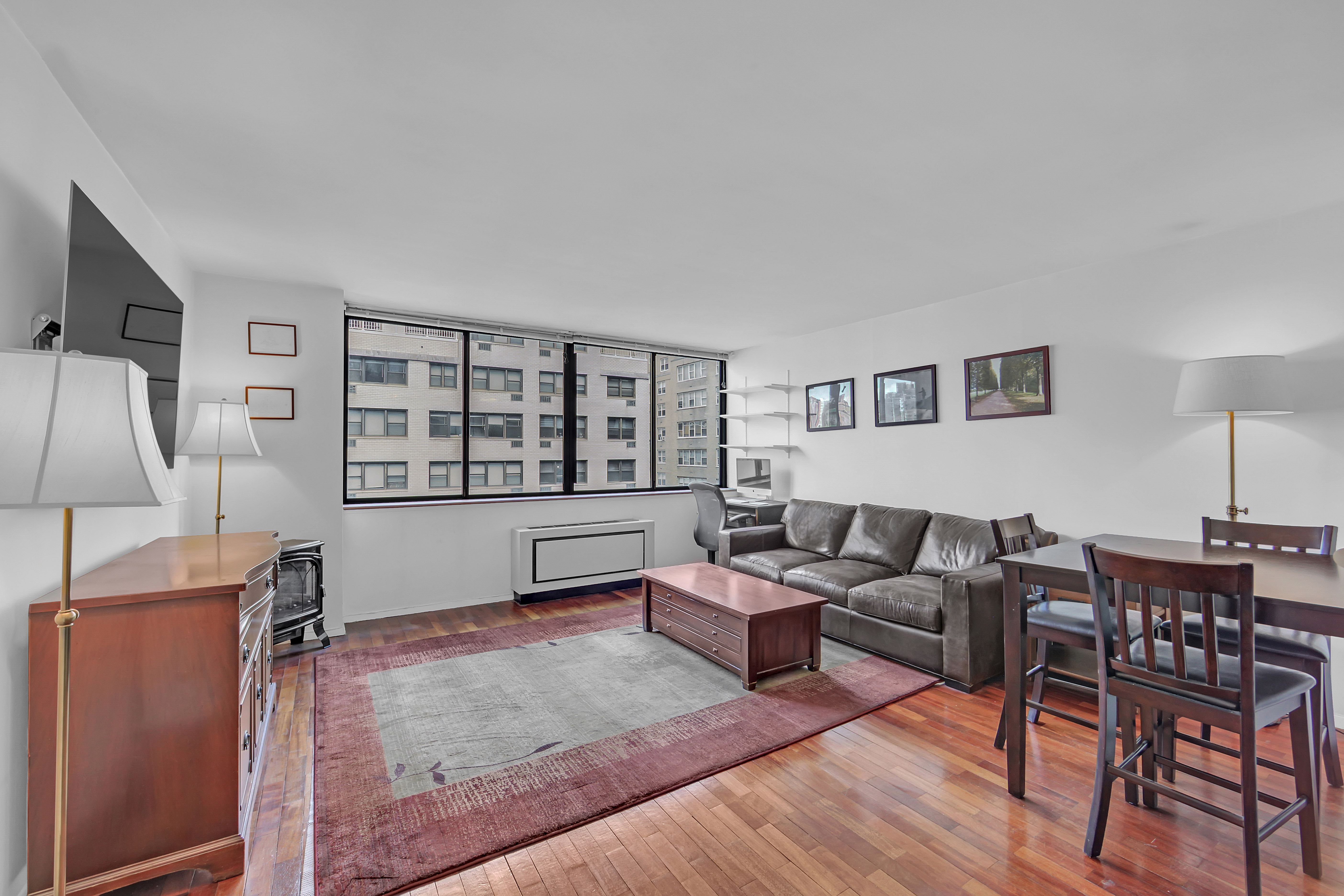 330 East 75th Street, Unit 8H Manhattan, NY 10021 - Photo 2 of 11 a living room with furniture and a window