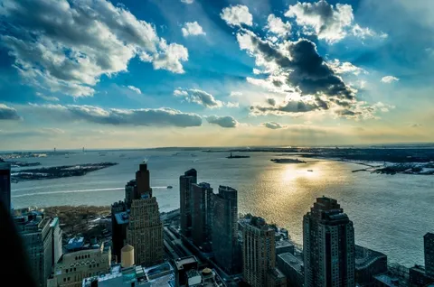 a view of a lake in front of residential houses with outdoor space