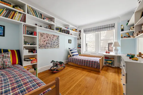 a bedroom with furniture and a book shelf