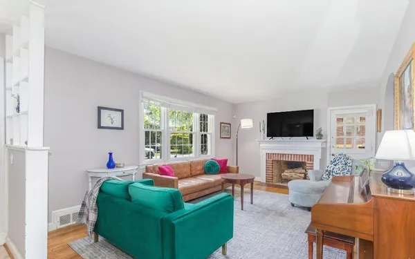 a living room with furniture a flat screen tv and a fireplace