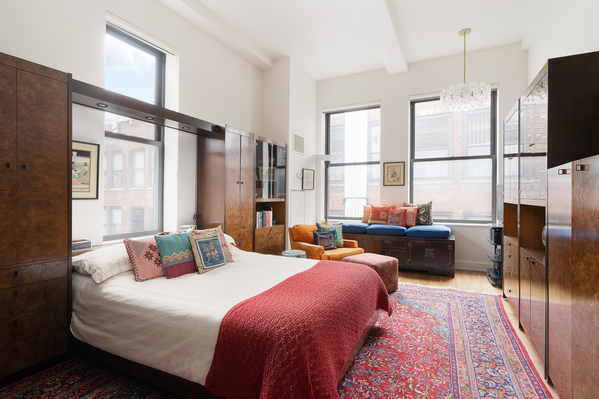 140 West 22nd Street, Unit PHC Manhattan, NY 10011 - Photo 6 of 15 a bedroom with furniture a flat screen tv and a large window