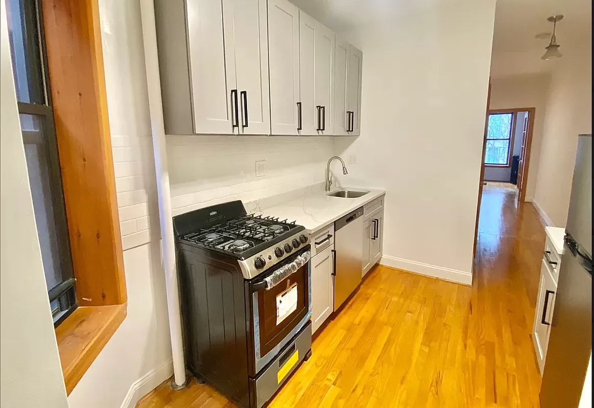 314 East 11th Street, Unit 3B Manhattan, NY 10003 - Photo 3 of 7 a kitchen with a sink and wooden floor