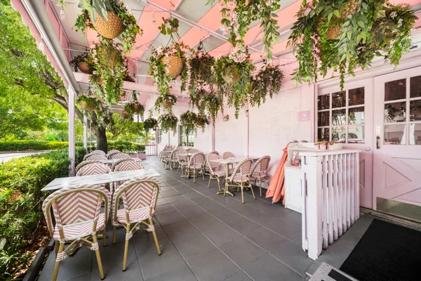 a view of a patio with table and chairs and potted plants