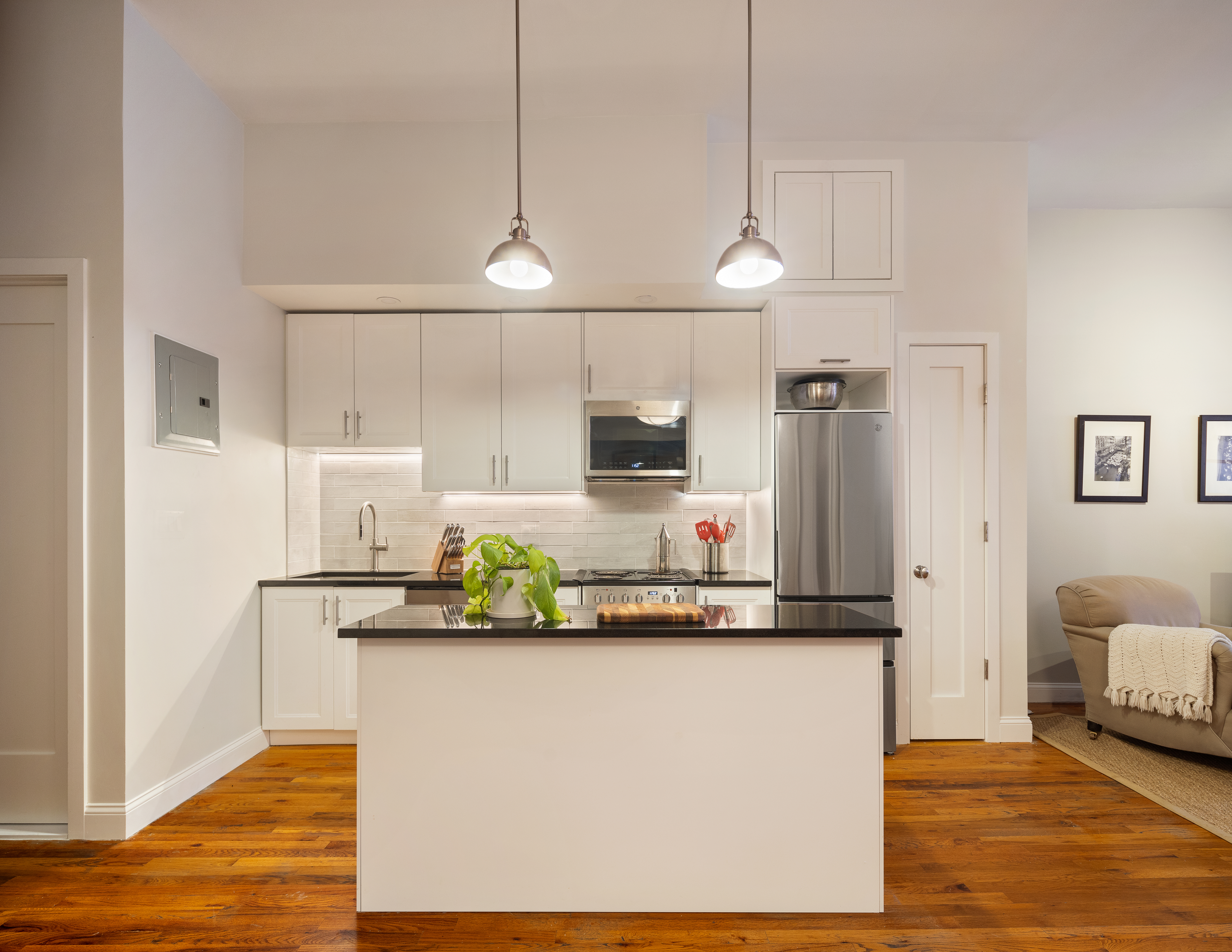 a kitchen with stainless steel appliances a refrigerator a sink and a counter