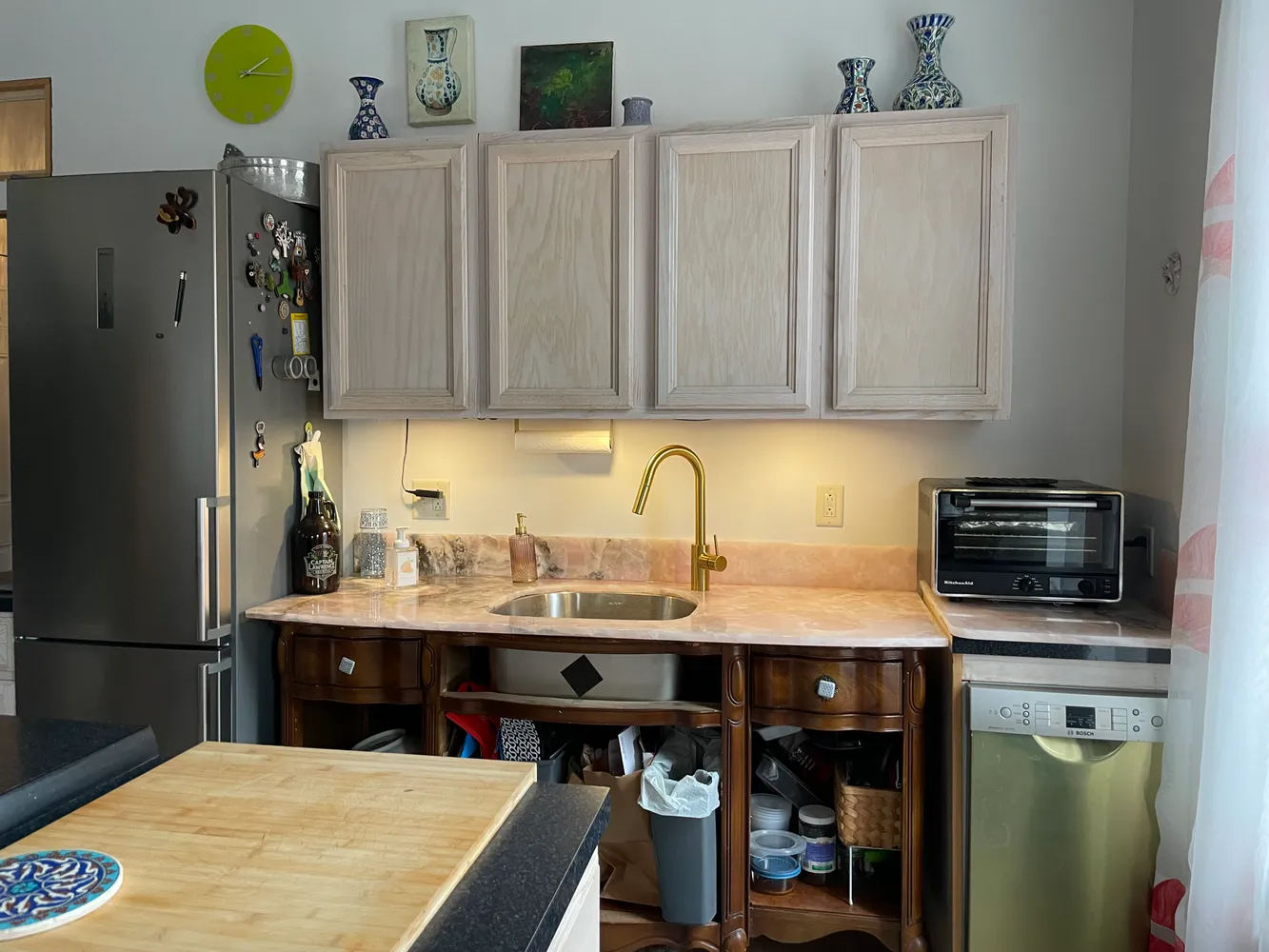 a kitchen with a sink a stove and cabinets