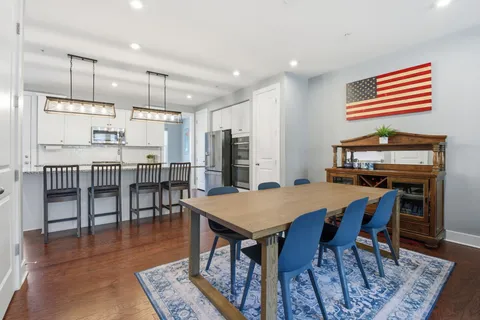 a dining room with furniture and wooden floor