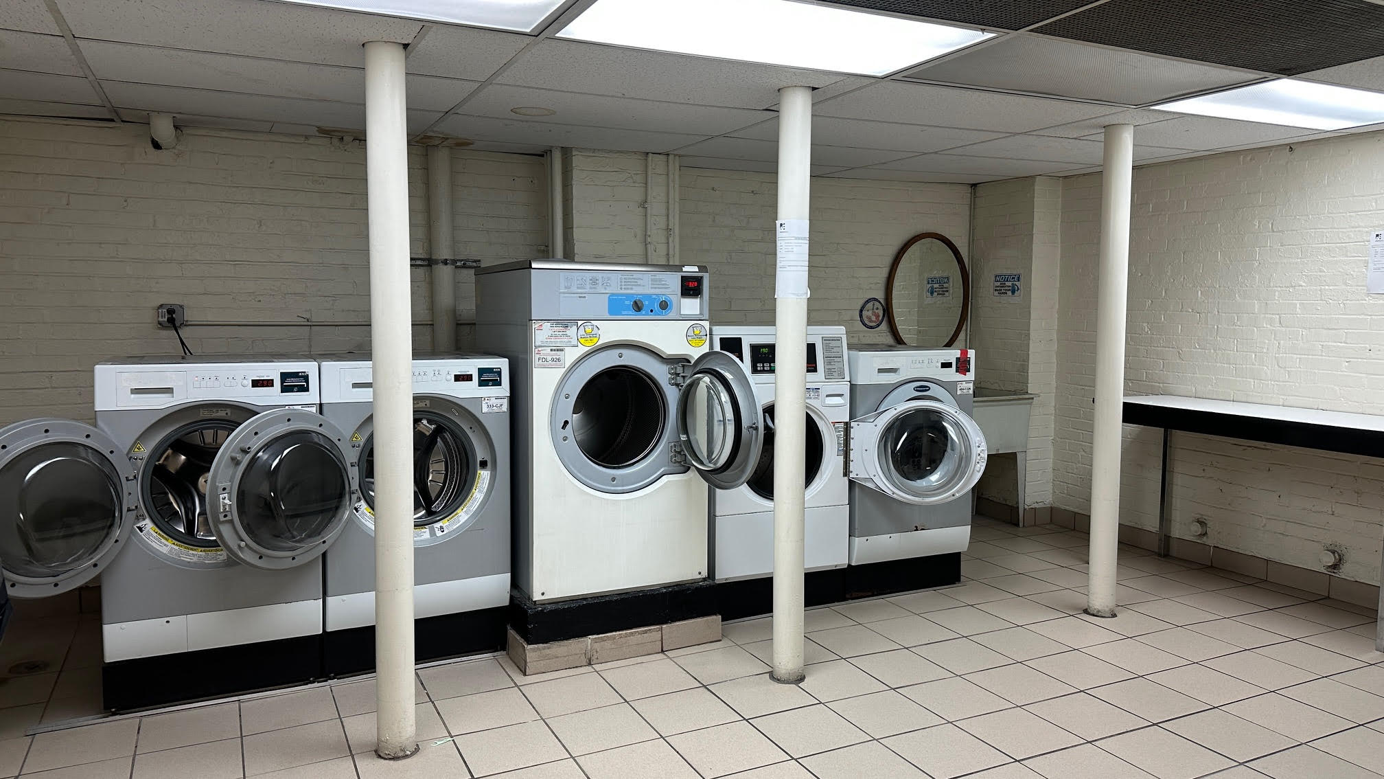 162 West 56th Street, Unit 1102 Manhattan, NY 10019 - Photo 9 of 12 a utility room with dryer and washer