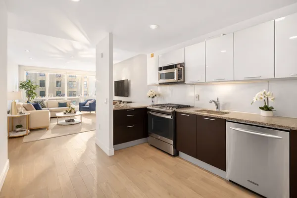 a kitchen with a sink stove and cabinets