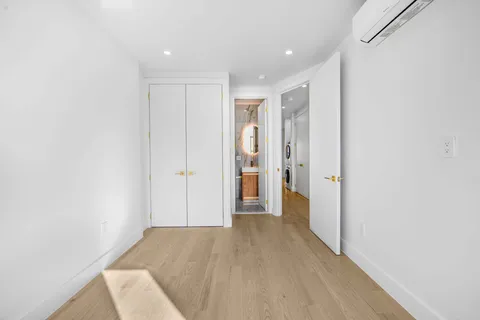a view of hallway with wooden floor