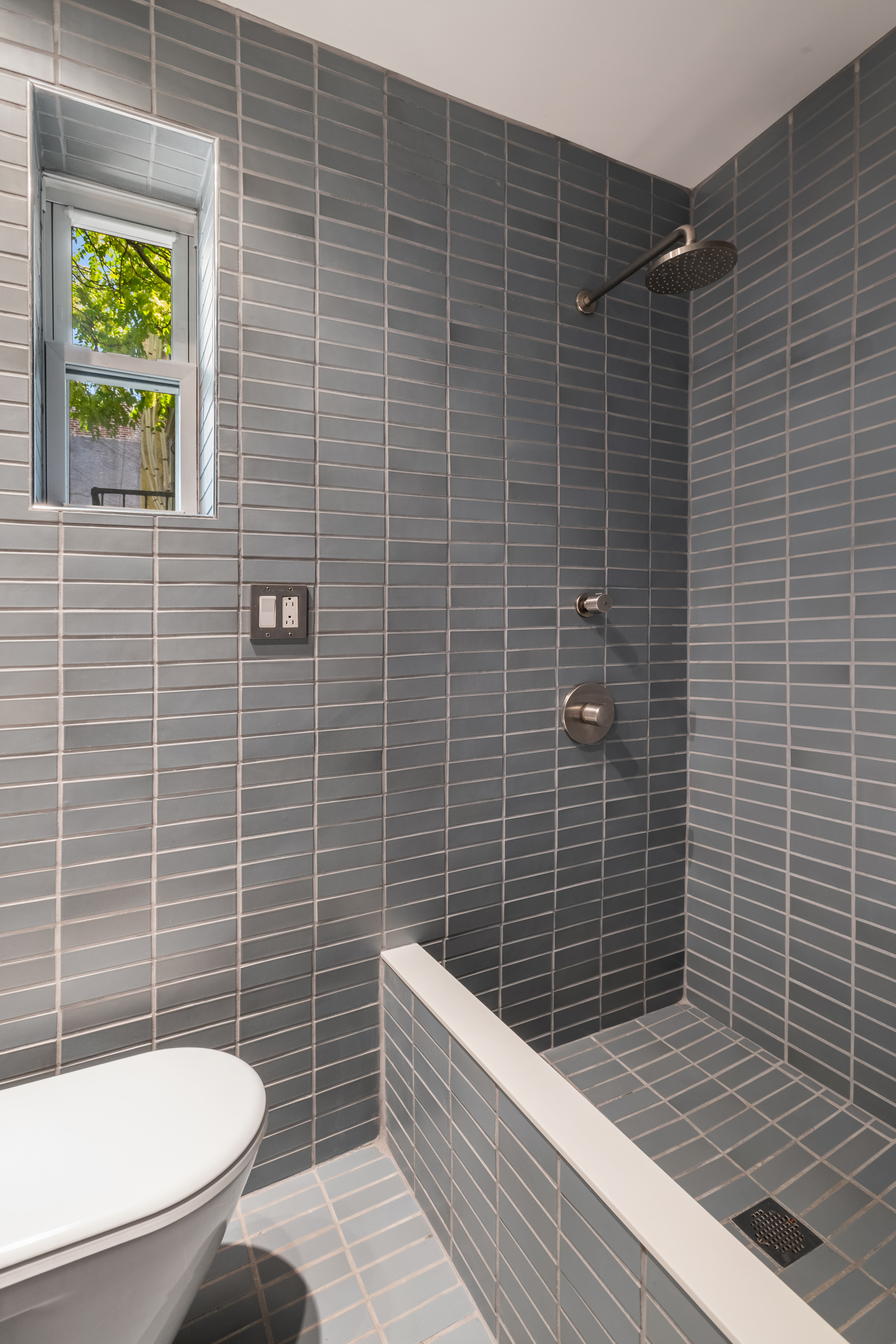 77 Perry Street, Unit 3D Manhattan, NY 10014 - Photo 5 of 11 a bathroom with a toilet a sink and a shower