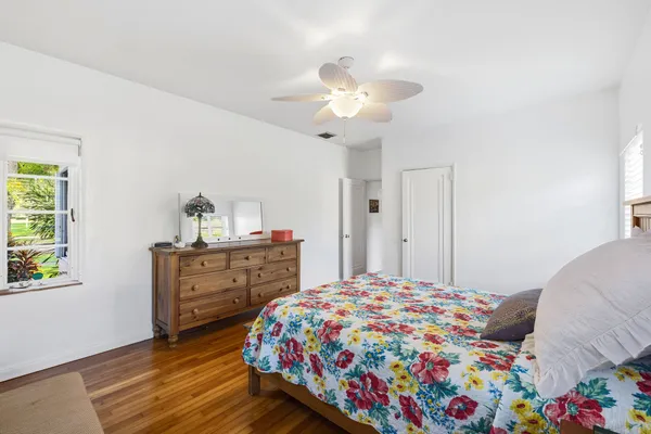 a bedroom with a bed and a dresser in it