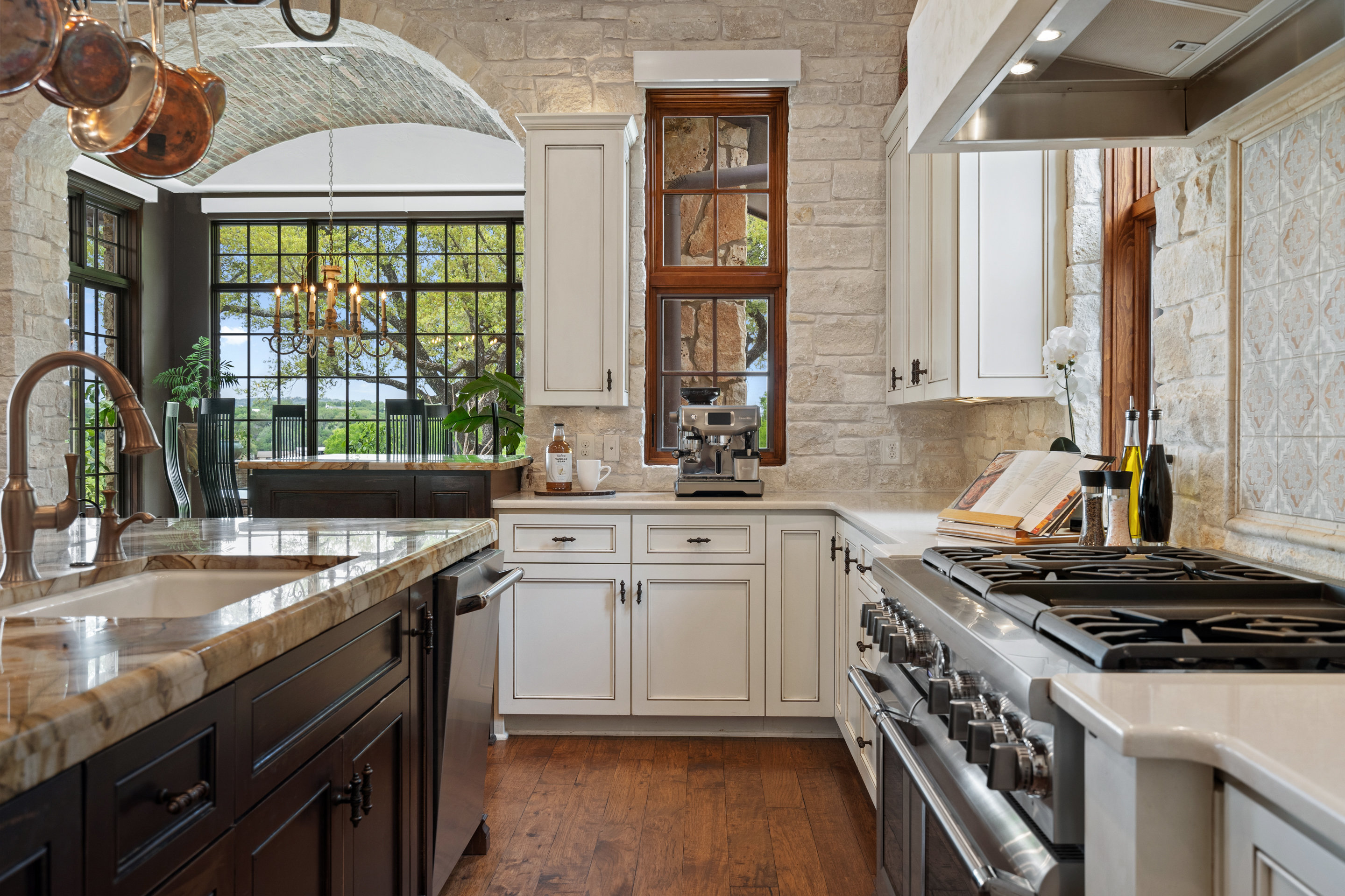 808 Rivercliff Drive Spicewood, TX 78669 - Photo 19 of 71 a kitchen with a stove a sink and a window