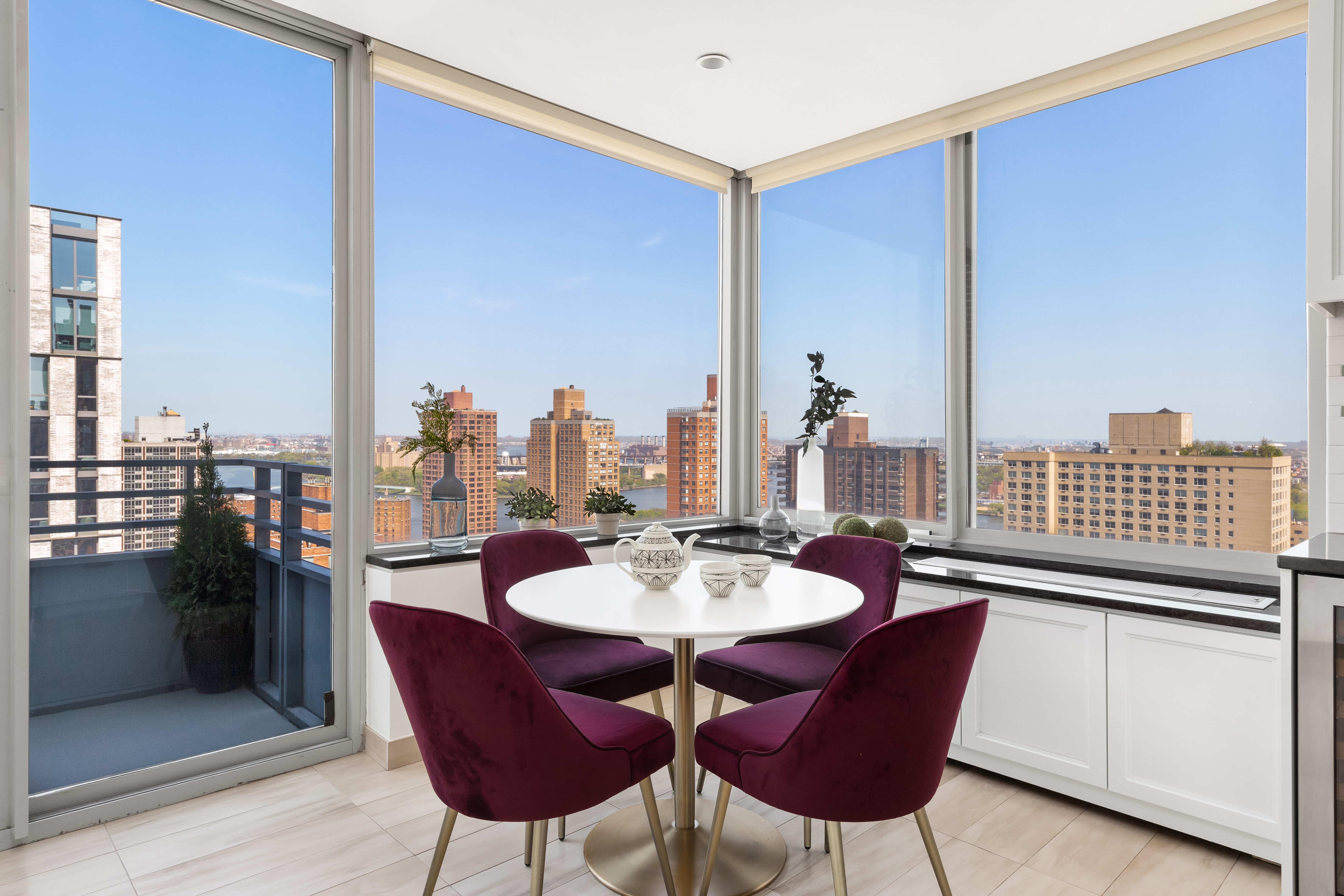 360 East 88th Street, Unit 31C Manhattan, NY 10128 - Photo 7 of 24 a dining room with furniture and a floor to ceiling window