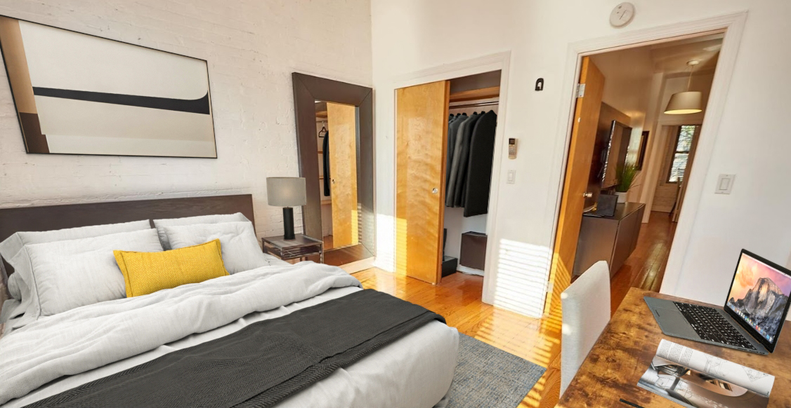 170 Elizabeth Street, Unit 1 Manhattan, NY 10012 - Photo 8 of 16 a bedroom with a bed and a flat screen tv