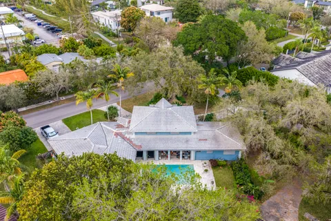 an aerial view of a house with a garden and swimming pool