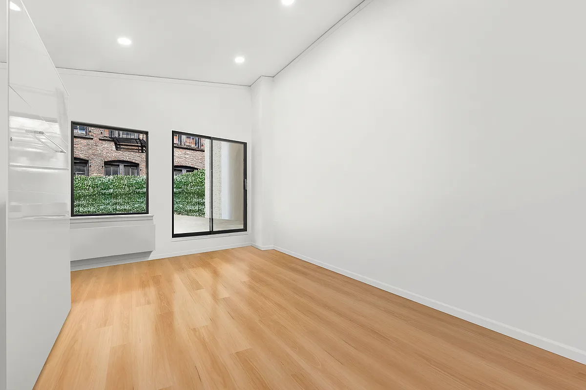 35 East 10th Street, Unit 2G Manhattan, NY 10003 - Photo 7 of 11 an empty room with windows